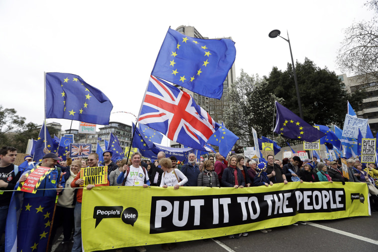Image: Demonstrators hold a banner during a Peoples Vote anti-Brexit march in London