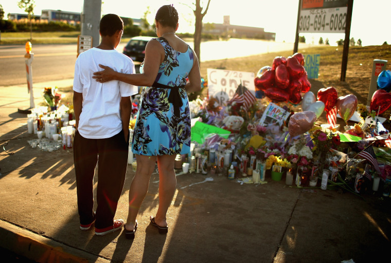 Image: Barb Whitfield and her grandson, Wanya Whitfield, visit a memorial to the victims of a movie theater shooting in Aurora, Colorado, on July 22, 2012.