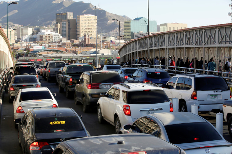 Image: Drivers and commuters wait in line to cross to El Paso, Texas, on the international border crossing bridge Paso del Norte, in Ciudad Juarez