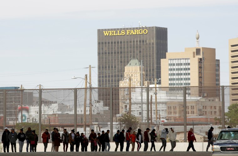 Image: Migrants from Central America are seen escorted by U.S. Customs and Border Protection officials after crossing into the United States illegally and turning themselves in to request asylum in El Paso, Texas, in this picture taken from Ciudad Juarez