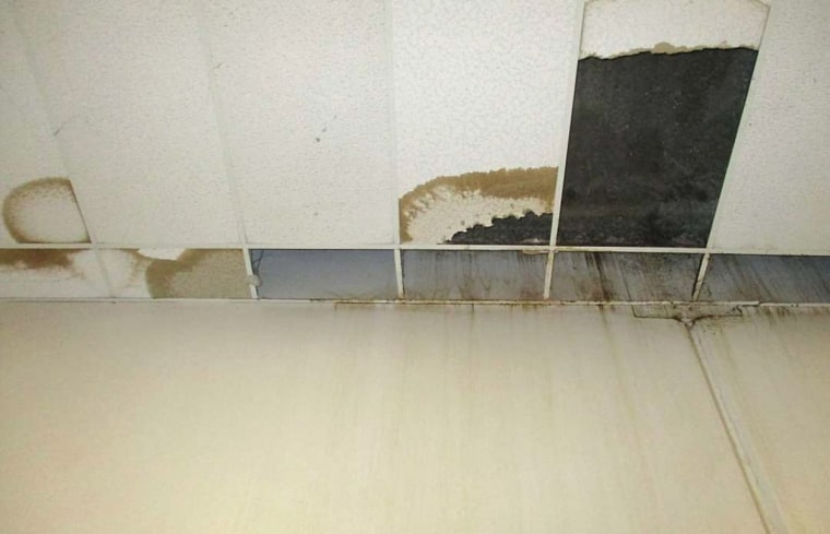 The front wall and ceiling of a dining hall where damaged ceiling tiles have been removed at the California Substance Abuse Treatment Facility and State Prison