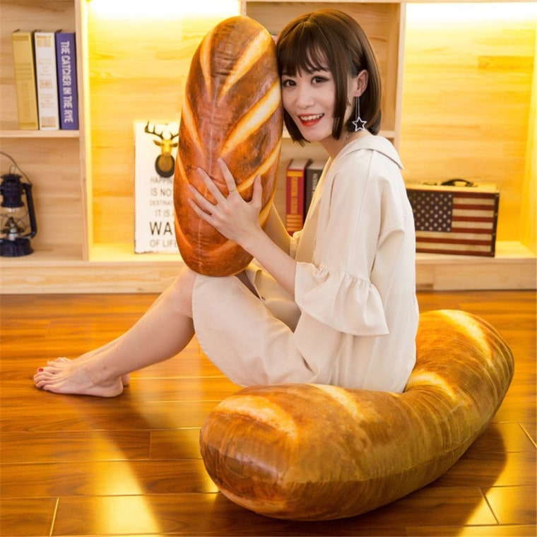 This pillow looks exactly like a loaf of bread and we need it