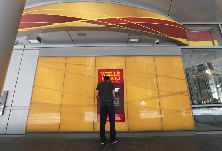 Image: A man uses a Wells Fargo ATM in Charlotte, North Carolina