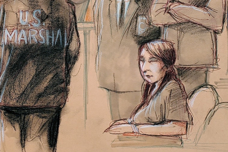Image: Yujing Zhang is seated upon arrival with U.S. Marshals, awaiting for the start of her hearing at the U.S. federal court in West Palm Beach