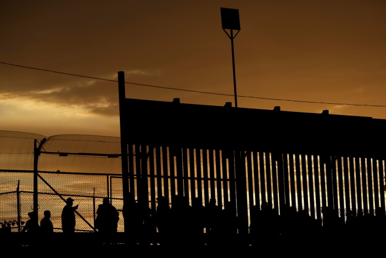Image: Migrants listen to U.S. Customs and Border Protection officials near the border with Mexico in El Paso, Texas, on April 5, 2019.