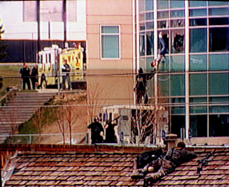 A Columbine High School student is rescued by emergency personnel during the shooting spree at the school in the southwest Denver suburb of Littleton, Colorado on April 20, 1999.