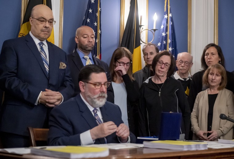 Image: Leigh Stein, daughter of victim Dan Stein, wipes away tears as Pittsburgh Mayor Bill Peduto signs three gun-control bills into law on April 9, 2019.