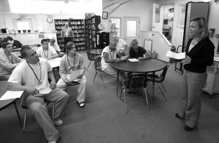 Missy Shea of the Vermont Secretary of State's office helps inmates at the Marble Valley Regional Correctional Facility through the voter registration process