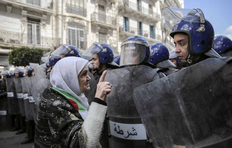 Image: woman confronts security forces