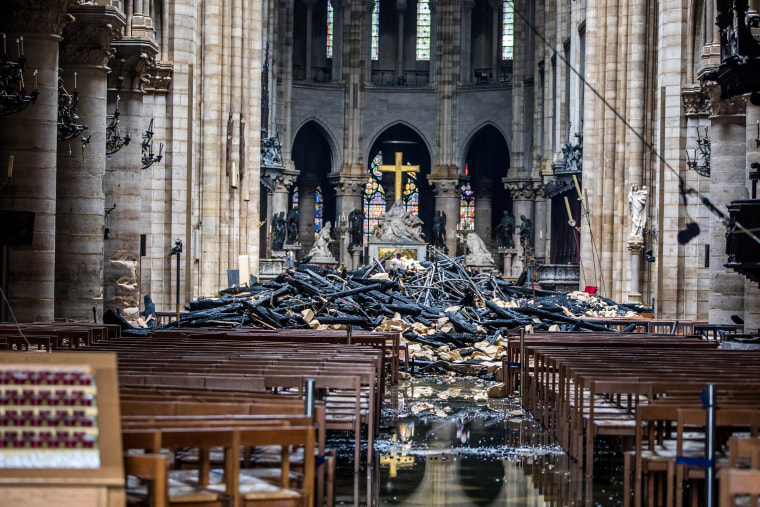 Image: A view of the debris inside Notre-Dame de Paris in the aftermath of a fire that devastated the cathedral, during the visit of French Interior Minister Christophe Castaner in Paris