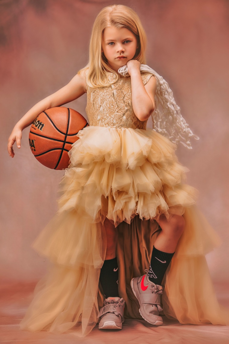 Mitchell photographed one child in a princess dress with a basketball.