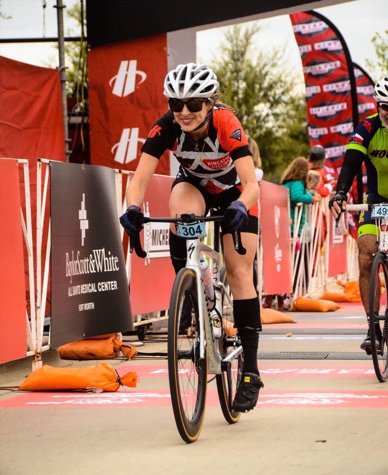 Crossing the finish line, clad in Lycra.