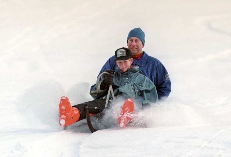 Prince Charles and Prince Harry sledding during a ski holiday in Switzerland.