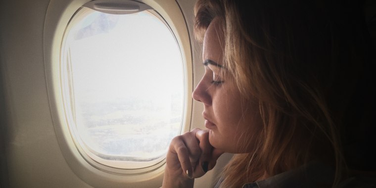 Close-Up Of Woman Traveling In Airplane