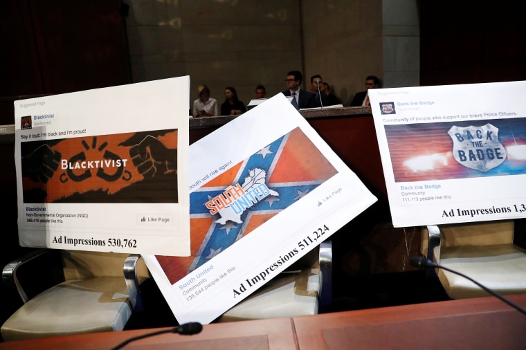 Image: Examples of Facebook pages are seen, as executives appear before the House Intelligence Committee to answer questions related to Russian use of social media to influence U.S. elections, on Capitol Hill in Washington