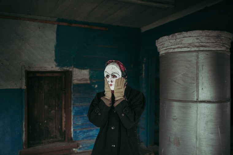 Artist Alisa Gorshenina in an abandoned house in Yakshina, Russia.