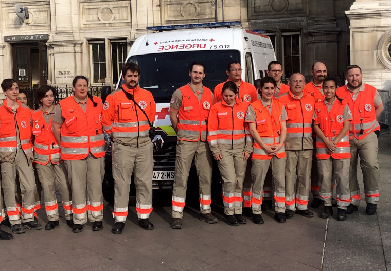 Image: Red Cross Paris members attend a ceremony with the Mayor of Paris on Thursday.