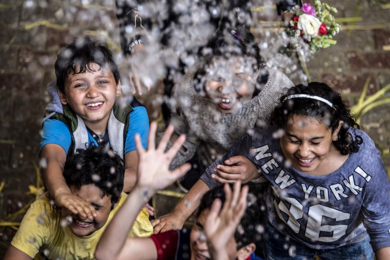 Image: Children are sprayed with holy water during Palm Sunday mass at the Saint Simon Church in Cairo, Egypt, on April 21, 2019.