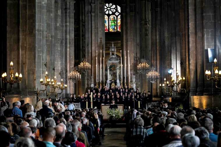 Image: Worshipers attend a tribute mass for Notre Dame Cathedral at the Saint Eustache Church in Paris on April 21, six days after a fire severely damaged the centuries-old church.