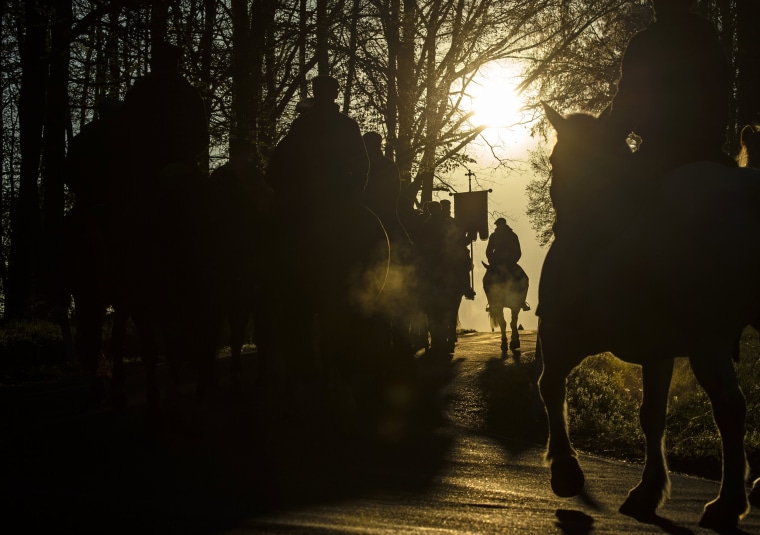 Image: Sorbs carry parish banners while riding horses during an Easter procession in Ostro, Germany, on April 21.