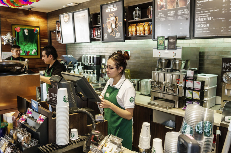 Employee baristas inside Starbucks Coffee