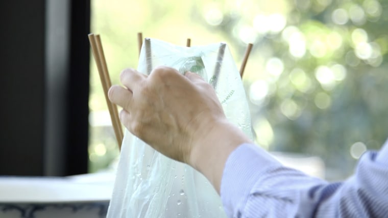 Silverstone washes and dries plastic bags to reuse. You can create a similar drying rack with a bottle and some chopsticks.