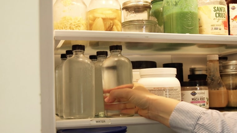 Alicia reduces plastic consumption by filling glass bottles with house-filtered water.