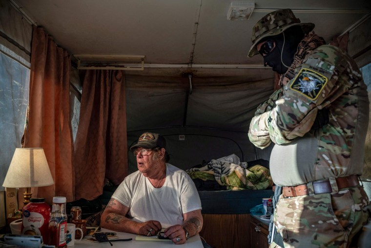 Image: Striker, the leader of the Constitutional Patriots militia, speaks with Viper, right, about logistics in Anapra, New Mexico, on March 20, 2019.