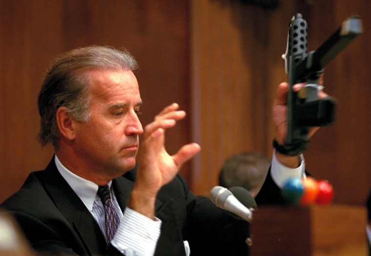Image: Sen. Joe Biden, chairman of the Senate Judiciary Committee, holds a TEC-9 semi-automatic weapon during a hearing on assault weapons at the Capitol on Aug. 3, 1993.