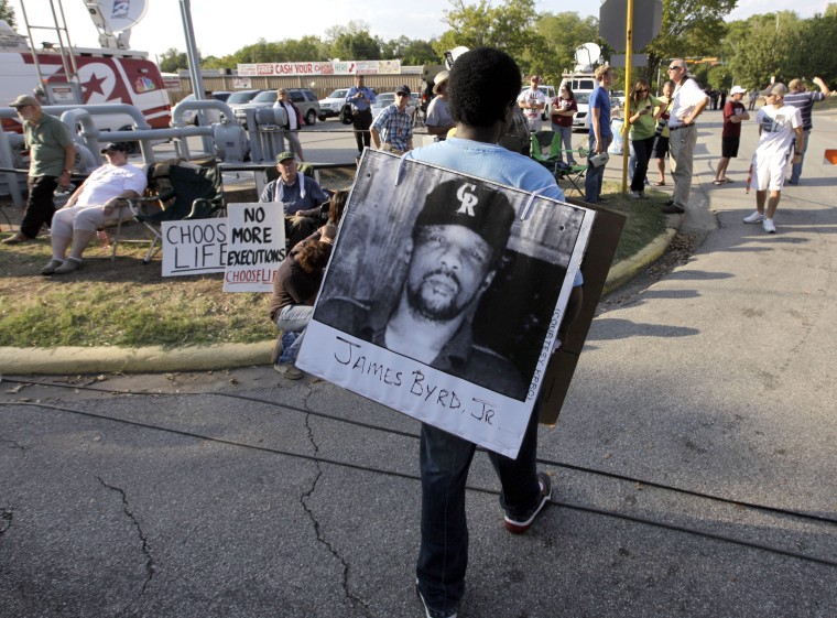 Image: Ricky Jason wears a photograph of James Byrd Jr. outside the Texas Department of Criminal Justice Huntsville Unit on Sept. 21, 2011.