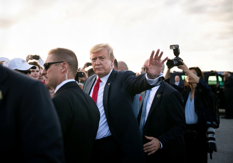 Image: U.S. President Donald Trump waves as he greets supporters on the tarmac at Palm Beach International Airport, as he arrives to spend Easter weekend at his Mar-a-Lago club, Florida