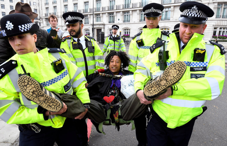 Image: Members of the police carry a demonstrator during the Extinction Rebellion protest at the Marble Arch in London