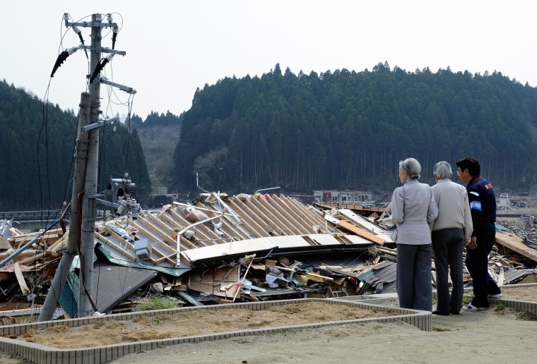 Image: Minamisanriku Mayor Jin Saito, Japanese Emperor Akihito and Empress Michiko look at tsunami devastation in 2011