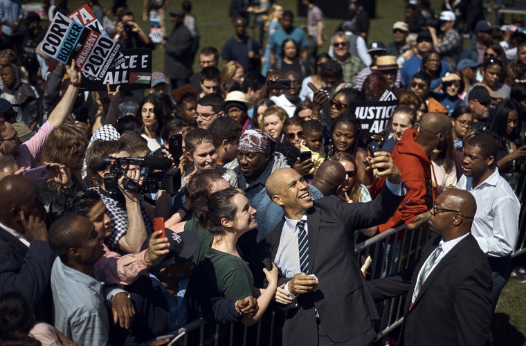 Image: Sen. Cory Booker, D-NJ, takes a selfie with supporters during his campaign kickoff event in Newark on April 13, 2019.