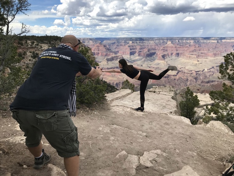 Image: Victoria Gizhyrova, 29, does a yoga pose a few feet from the edge of the South Rim in the Grand Canyon