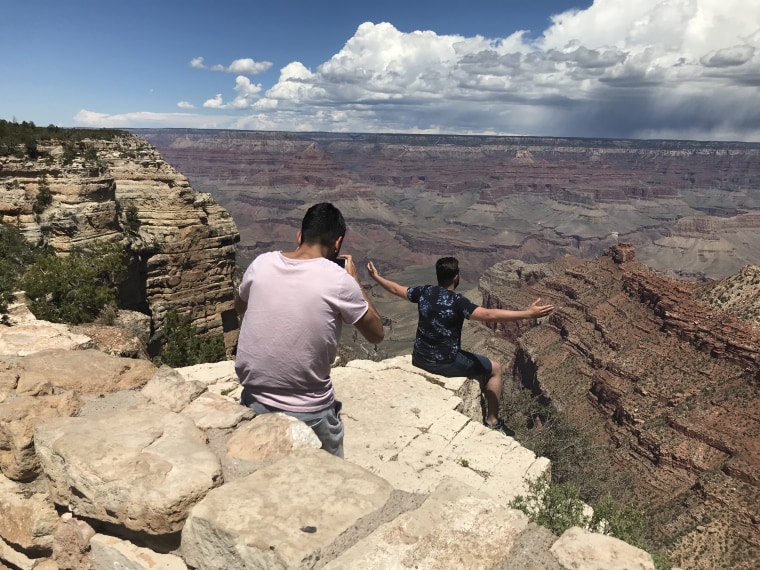 Anass el Mesoudi sits on the edge while his friend, Hachim Alkabere, takes photos. 