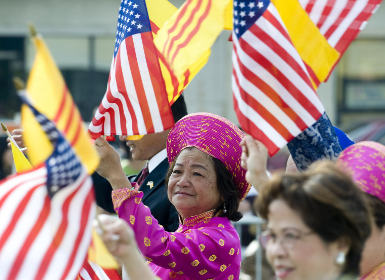 Image: People wave flags during the Tet Parade