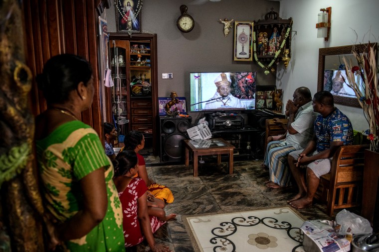 Image: A family watches a televised mass led by Cardinal Malcom Ranjith, a week after a series of bomb attacks at churches, in Colombo, Sri Lanka on April 28, 2019.
