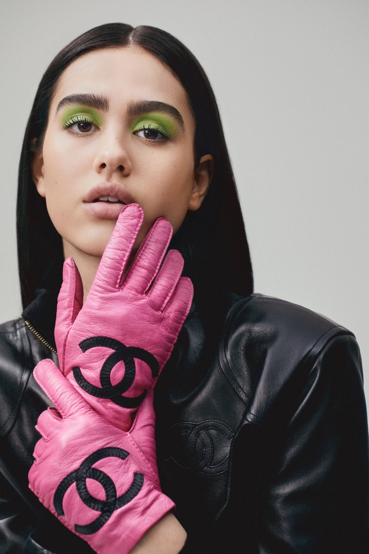 Amelia Gray wears hot pink Chanel gloves for the What Comes Around Goes Around shoot.