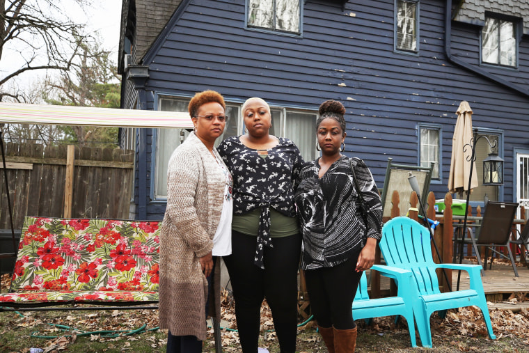 Monique, Ashley Gunn and Alicia stand outside Ashley's house