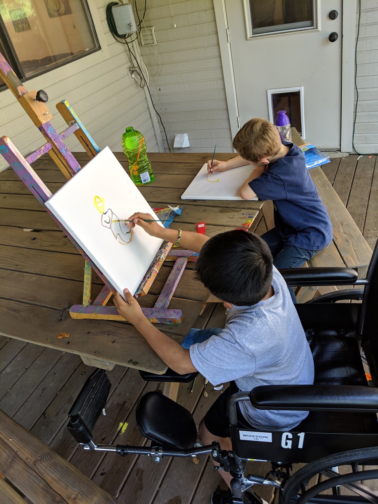 Desmond Sewell, 6, and Byron Xol, 8, draw at the Sewell home in Buda, Texas.