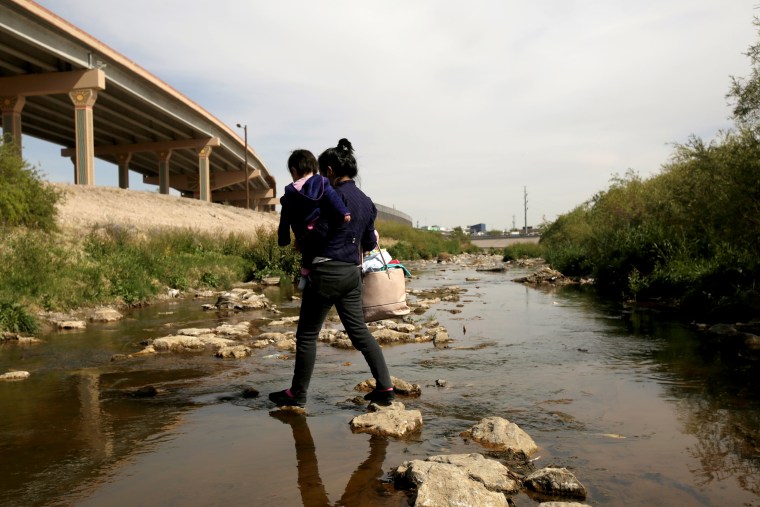 Image: A Central American migrant and her baby cross the Rio Bravo to request asylum in the United States near El Paso on April 1, 2019.