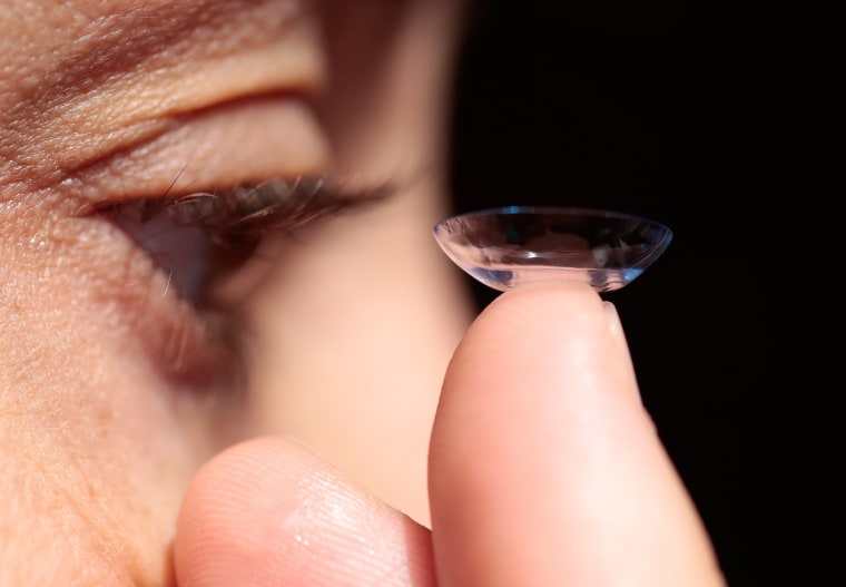 Image: Woman putting in a contact lens