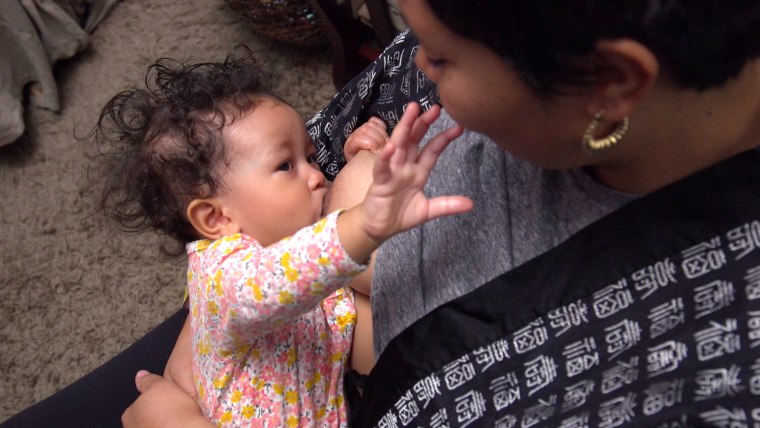 Elisa Gomera breastfeeds her baby girl, Emme.