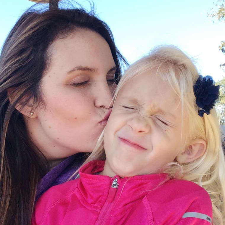 Kristen Skiles kisses her stepdaughter on the cheek.
