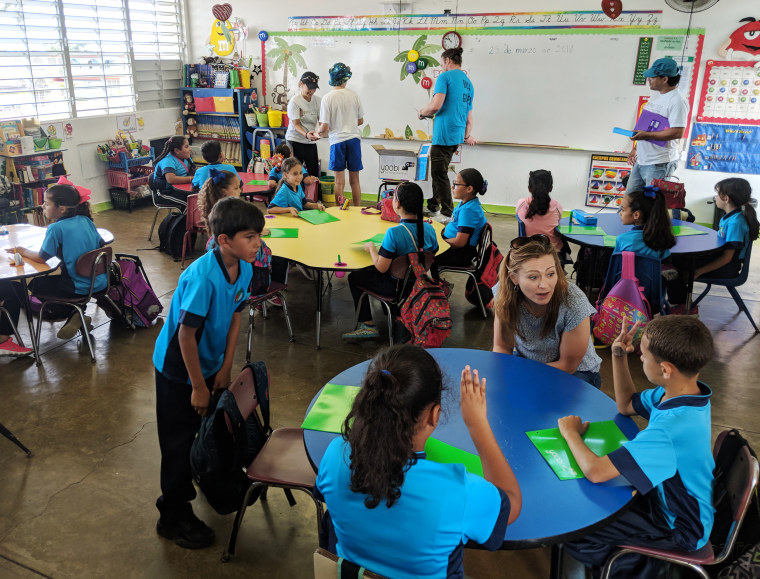 Image: Former Obama adminstration officials visit students at the Isaac del Rosario Elementary School in Catano, Puerto Rico
