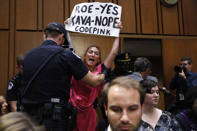 Image: A protester is escorted out of the Kavanaugh confirmation hearing
