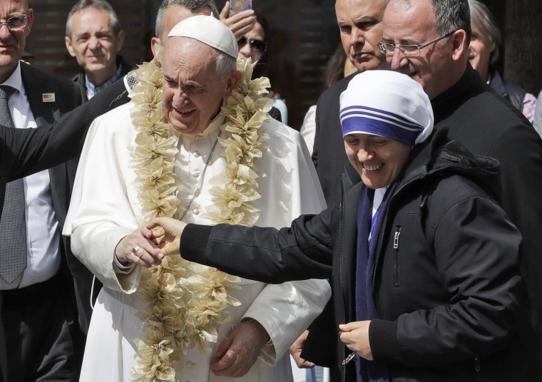 Image: Pope Francis is welcomed by a nun as he arrives at Mother Teresa's memorial in Skopje, North Macedonia