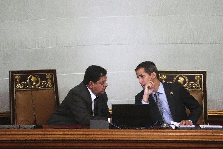Image: Venezuelan opposition leader Juan Guaido, who many nations have recognised as the country's rightful interim ruler, talks to Edgar Zambrano, the assembly vice president, in a session of the National Assembly in Caracas