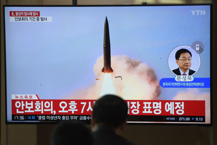 Image: People watch a television news programme showing file footage of North Korea's projectile weapons, at a railway station in Seoul